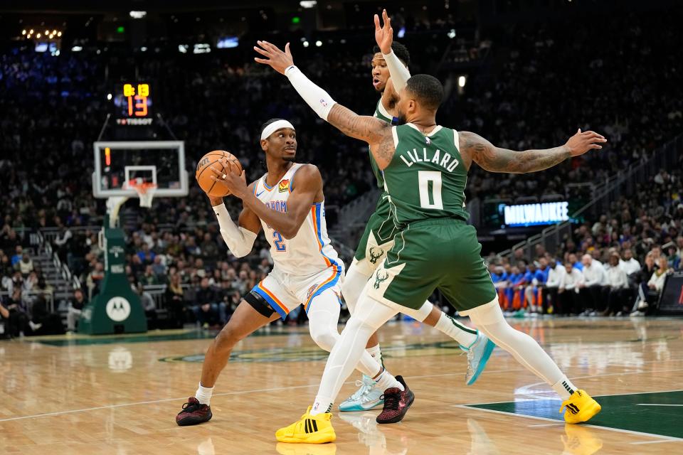 Mar 24, 2024; Milwaukee, Wisconsin, USA; Oklahoma City Thunder guard Shai Gilgeous-Alexander (2) looks to pass the ball under pressure from Milwaukee Bucks forward Giannis Antetokounmpo (34) and guard Damian Lillard (0) during the first quarter at Fiserv Forum. Mandatory Credit: Jeff Hanisch-USA TODAY Sports