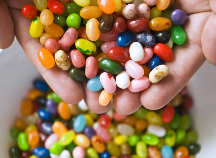 hands holding many jelly beans