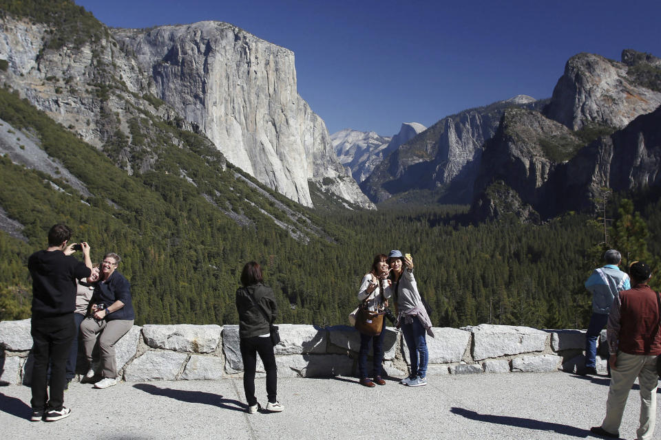 FILE - Visitors at Tunnel View enjoy the views of Yosemite National Park, Calif., on Oct. 17, 2013. The U.S. Senate has unanimously approved the nomination of Charles "Chuck" Sams III as National Park Service director, which will make him the first Native American to lead the agency that oversees more than 131,000 square miles of parks and other landmarks. (AP Photo/Gary Kazanjian, File)