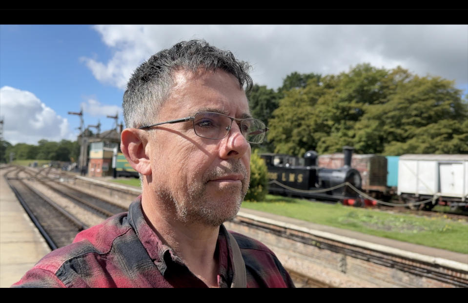 Close up of mans face at a train station