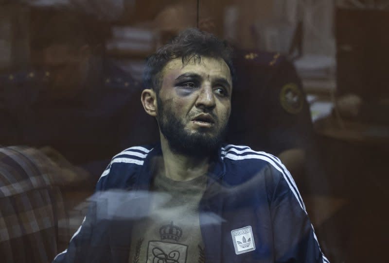 \A suspect in the shooting attack on the Crocus City Hall concert venue sits inside a defendant's enclosure during a hearing on pretrial restrictions at Basmanny district court, in Moscow, Russia, on Sunday. At least 137 people were killed and more than 180 hospitalized after a group of gunmen attacked the concert hall in the Moscow region on Friday evening, Russian officials said. Eleven suspects, including all four gunmen directly involved in the terrorist attack, have been detained, according to Russian authorities. Photo by Sergei Ilnitsky/EPA-EFE