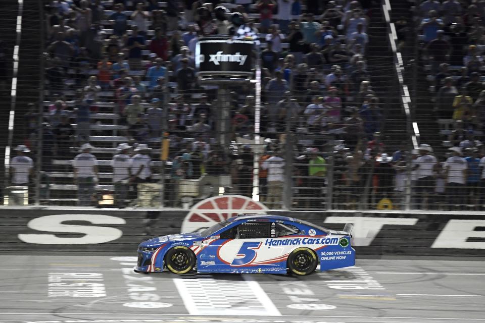 FILE - Kyle Larson takes the checkered flag to win the NASCAR Cup Series All-Star auto race at Texas Motor Speedway in Fort Worth, Texas, June 13, 2021. Reigning series Cup champion Larson has won his last two All-Star starts, last year in his debut season with Hendrick Motorsports after taking the checkered flag at the 2019 race in Charlotte while still with Chip Ganassi Racing. (AP Photo/Larry Papke, File)