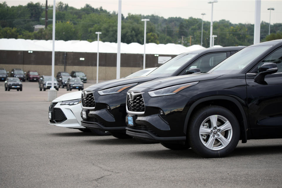 In this Sunday, Aug. 29, 2021, file photo, a pair of unsold 2021 Highlander sports utility vehicles and a Camry sedan are parked on the empty storage lot outside a Toyota dealership in Englewood, Colo. A global shortage of computer chips has forced automakers to temporarily close factories, limiting production and driving up prices. The coronavirus delta variant is now causing shortages of other parts. (AP Photo/David Zalubowski, File)