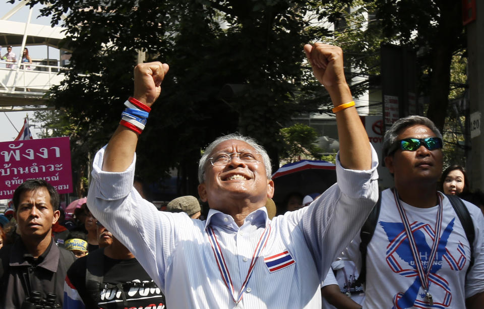 Anti-government protest leader Suthep Thaugsuban waves to supporters during a march through Bangkok, Thailand, Monday, Feb. 3, 2014. Thai protesters vowed Monday to stage larger rallies in central Bangkok and push ahead their efforts to nullify the results of elections that were expected to prolong a national political crisis. (AP Photo/Wally Santana)