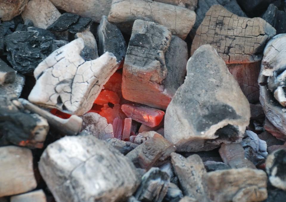 Cooking over an open flame – whether from gas, wood or charcoal – allows you to use both radiant and conductive heat to cook food. <a href="https://commons.wikimedia.org/wiki/File:Charbon_de_bois_rouge.jpg#/media/File:Charbon_de_bois_rouge.jpg" rel="nofollow noopener" target="_blank" data-ylk="slk:Romary/Wikimedia Commons;elm:context_link;itc:0;sec:content-canvas" class="link ">Romary/Wikimedia Commons</a>, <a href="http://creativecommons.org/licenses/by-sa/4.0/" rel="nofollow noopener" target="_blank" data-ylk="slk:CC BY-SA;elm:context_link;itc:0;sec:content-canvas" class="link ">CC BY-SA</a>