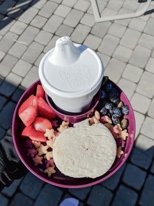 A kid-friendly travel tray because it'll fit in your little one's car seat or stroller, making it easier to ensure they're eating their fruits and Cheerios