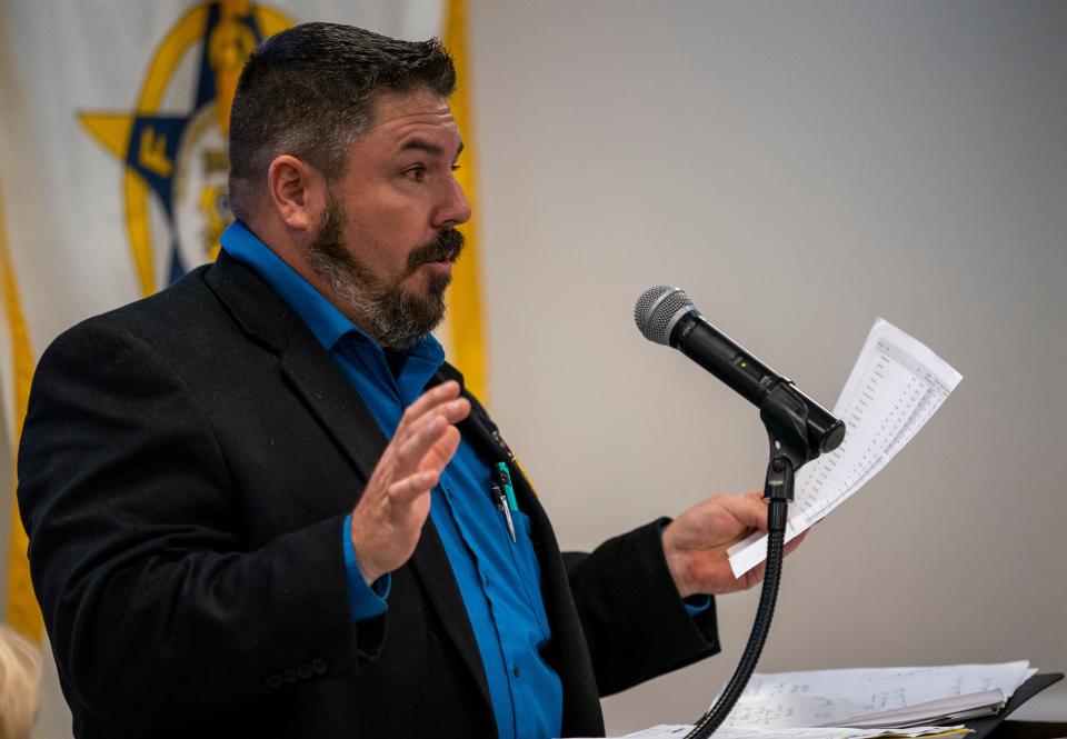 Evansville mayoral Libertarian candidate Michael Daugherty holds up a page of the expenditure budget while speaking to the crowd during the Fraternal Order of Police Lodge #73 PAC night in Evansville, Ind., Wednesday, Aug. 23, 2023.