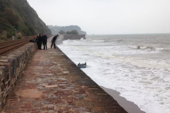 Driver in lucky escape as BMW plunges 20ft into sea in Devon