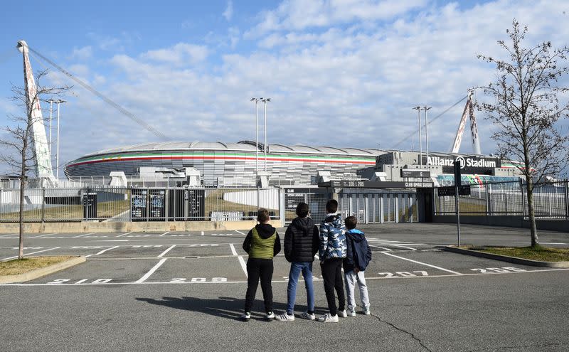 Boys look at the Allianz Stadium in Turin