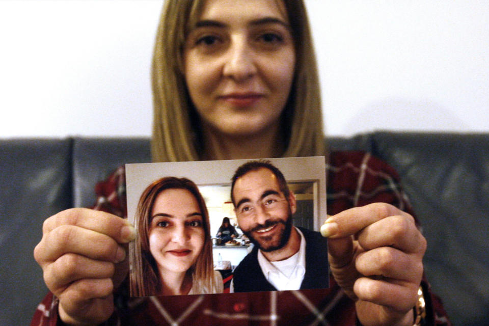 FILE - In this July 30, 2019, file photo, Aya Al-Umari, whose brother Hussein was killed in the Christchurch mosque attacks, poses, holding a photo of herself and her brother, in Christchurch, New Zealand. Al-Umari is one of more than 60 survivors and family members who this week in court will confront the white supremacist who committed the worst atrocity in New Zealand’s modern history, when he slaughtered 51 worshippers at two Christchurch mosques in March 2019. The four-day sentencing starts on Monday, Aug. 24, 2020.(AP Photo/Nick Perry, File)