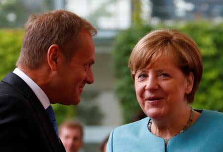 European Council President Donald Tusk is welcomed by German Chancellor Angela Merkel at the Chancellery in Berlin, Germany June 29, 2017. REUTERS/Fabrizio Bensch