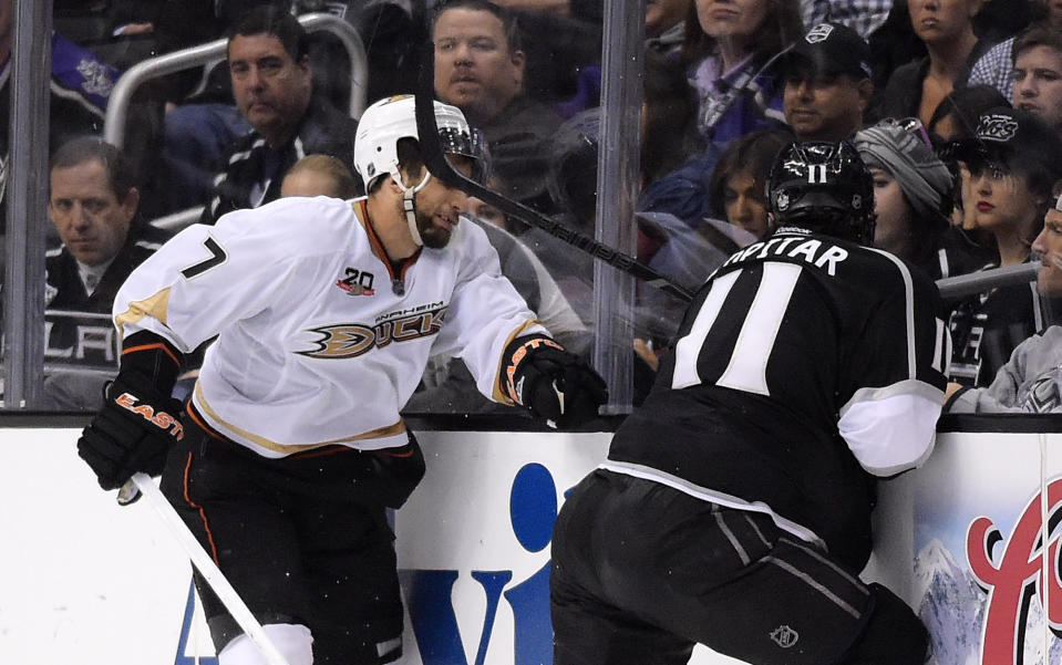 Los Angeles Kings center Anze Kopitar, right, of Slovenia, hits Anaheim Ducks center Andrew Cogliano in the face with his stick during the third period in Game 4 of an NHL hockey second-round Stanley Cup playoff series, Saturday, May 10, 2014, in Los Angeles. Kopitar received a four minute double minor for high sticking on the play. The Duck won 2-0. (AP Photo/Mark J. Terrill)