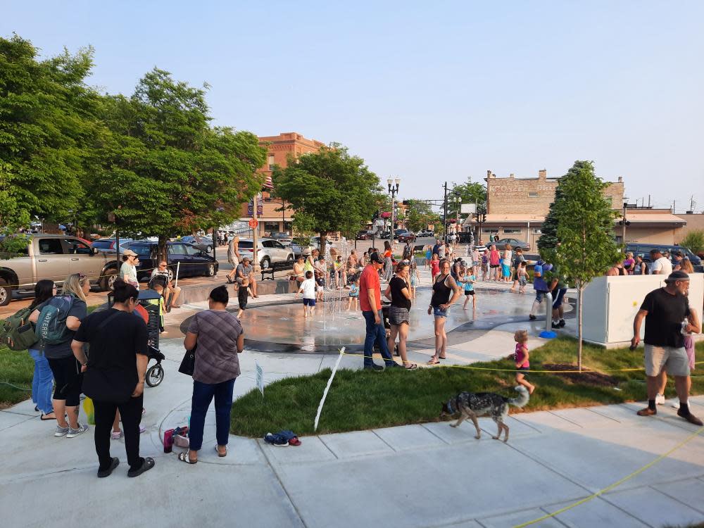 People enjoy the splash pad and new amenities at Central Park West in downtown Two Rivers.