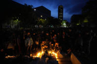 People light candles for the victims near the Vladislav Ribnikar school in Belgrade, Serbia, Wednesday, May 3, 2023. Police say a 13-year-old who opened fire at his school drew sketches of classrooms and made a list of people he intended to target. He killed eight fellow students and a school guard before being arrested. (AP Photo/Darko Vojinovic)