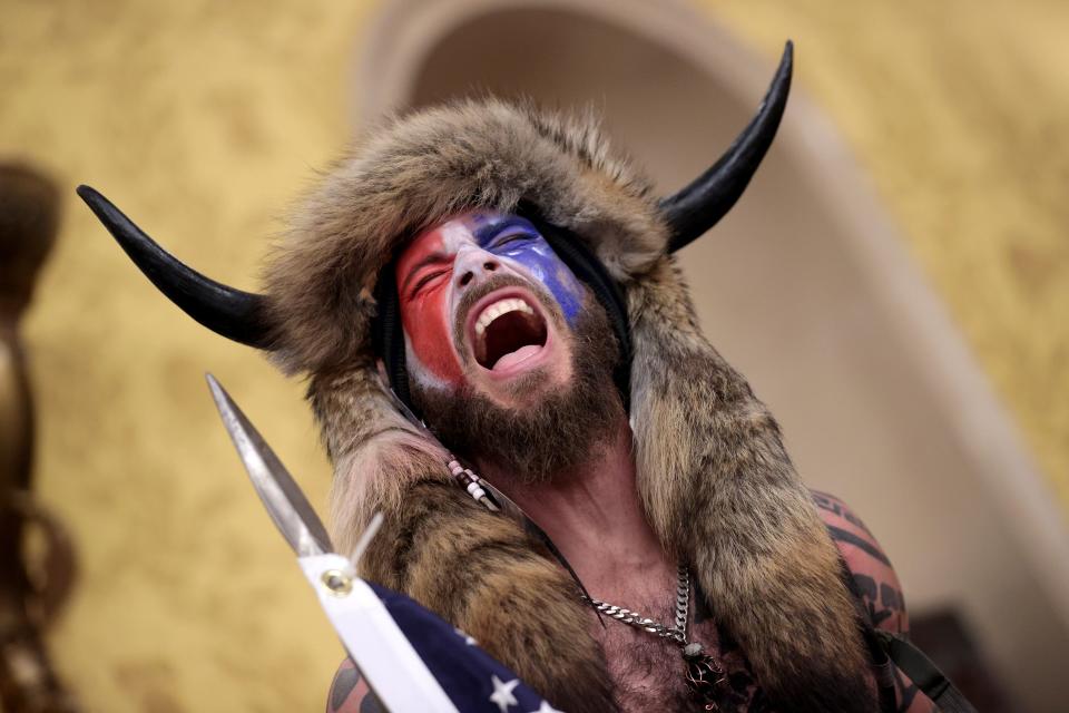 A supporter of Donald Trump screams, "Freedom!" inside the Senate chamber after the U.S. Capitol was breached by a mob.