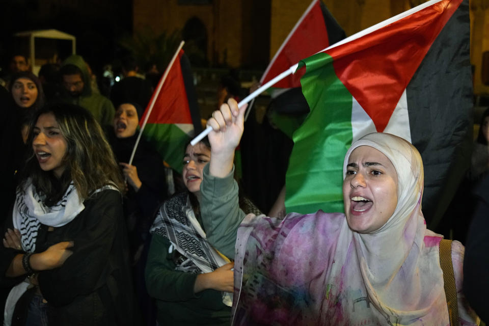 Demonstrators chant slogans during a protest in solidarity with the Palestinian people in Gaza, at Martyrs' Square in downtown Beirut, Lebanon, Tuesday, Oct. 17, 2023. Groups of protesters roamed the city on motorcycles and gathered outside the French embassy, and the headquarters of the U.N. Economic and Social Commission for Western Asia. They were unable to reach the heavily fortified U.S. embassy compound in the hills north of Beirut. (AP Photo/Bilal Hussein)