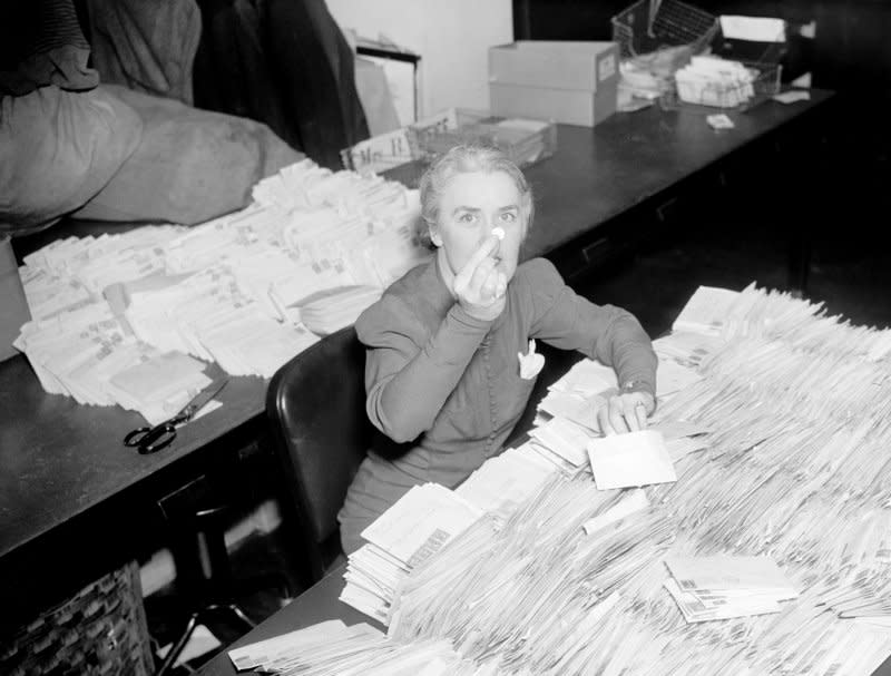 Missy LeHand, secretary to President Franklin D. Roosevelt, sorts through the morning mail at the White House in response to an appeal to donate dimes to fight infantile paralysis as a way of celebrating the president's birthday -- the first "March of Dimes" campaign. The March of Dines was established January 3, 1938. File Photo by Library of Congress