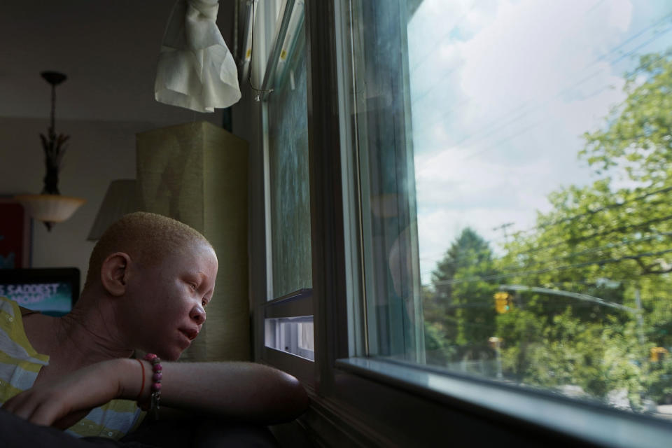 Pendo Noni looks out of the window at home in Staten Island