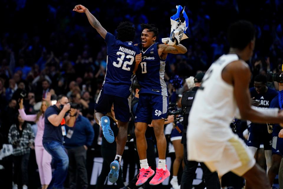 Jaylen Murray, left, and Latrell Reid celebrate after Saint Peter's upset Purdue to reach the Elite Eight.