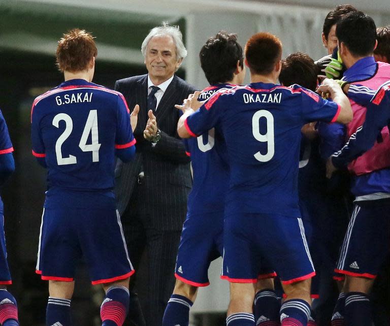 Japan's coach Vahid Halilhodzic celebrates a goal with some of the players during a friendly match against Uzbekistan in Tokyo last month