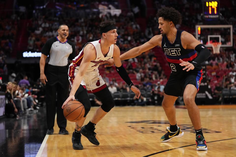 Miami Heat guard Tyler Herro (14) drives the ball around Detroit Pistons guard Cade Cunningham (2) during the second half at Kaseya Center in Miami on Wednesday, Oct. 25, 2023.