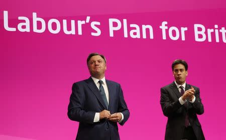 Britain's shadow chancellor Ed Balls (L) acknowledges applause as Britain's opposition Labour Party leader Ed Miliband looks on after his speech during Labour's annual conference in Manchester, northern England September 22, 2014. REUTERS/Suzanne Plunkett