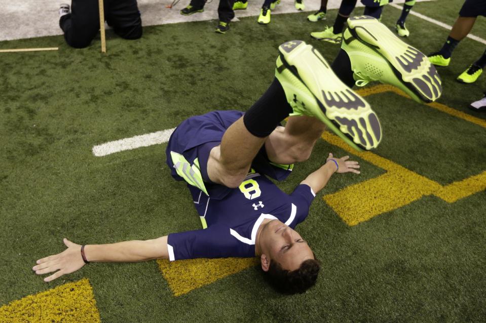 Texas A&M quarterback Johnny Manziel is measured for flexibility at the NFL football scouting combine in Indianapolis, Sunday, Feb. 23, 2014. (AP Photo/Michael Conroy)