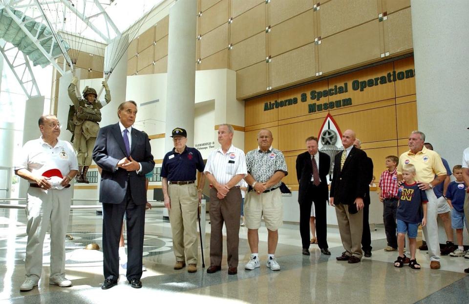 Former U.S. Sen. Bob Dole, second from left, addresses well-wishers during his one-hour visit to the Airborne & Special Operations Museum in Fayetteville in July of 2002. Bob Dole received two Purple Hearts and the Bronze Star Medal for service in World War II. He died on Sunday, Dec. 5, 2021.