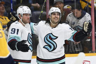 Seattle Kraken right wing Daniel Sprong (91) celebrates with center Jaden Schwartz (17) after scoring against the Nasvhille Predators during the first period of an NHL hockey game Thursday, March 23, 2023, in Nashville, Tenn. (AP Photo/Mark Zaleski)