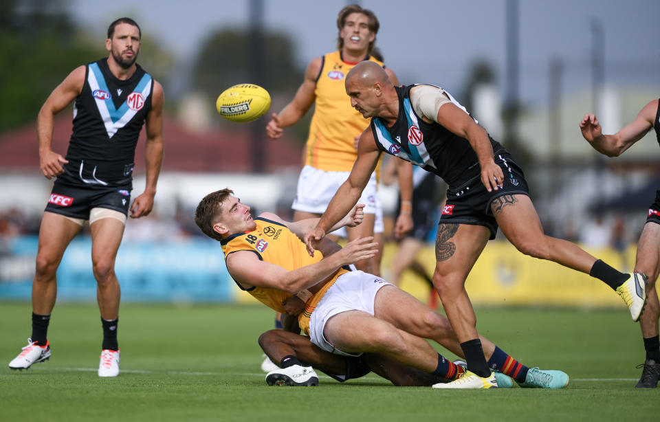 ADELAIDE, AUSTRALIA - FEBRUARY 23:  Mark Keane of the Crows  tackled by Willie Rioli of the Power and  Sam Powell-Pepper of the Power causing a concussion during an AFL practice match between Port Adelaide Power and Adelaide Crows at Alberton Oval on February 23, 2024 in Adelaide, Australia. (Photo by Mark Brake/Getty Images)