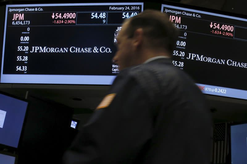 A trader works by the post where JPMorgan Chase & Co is traded on the floor of NYSE