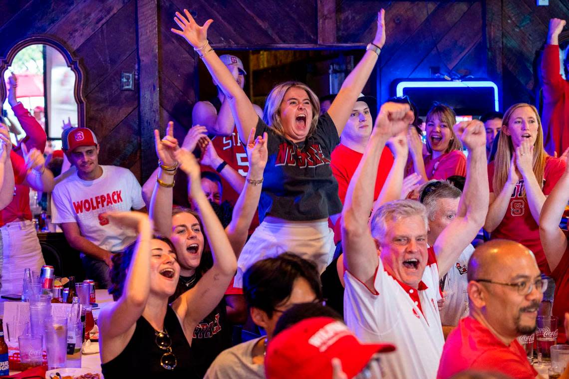 NC state fans at Players’ Retreat in Raleigh celebrate a Wolfpack lead against Duke during the second half of the Elite Eight round of the NCAA Men’s Division I Basketball Tournament on Sunday, March 31, 2024.