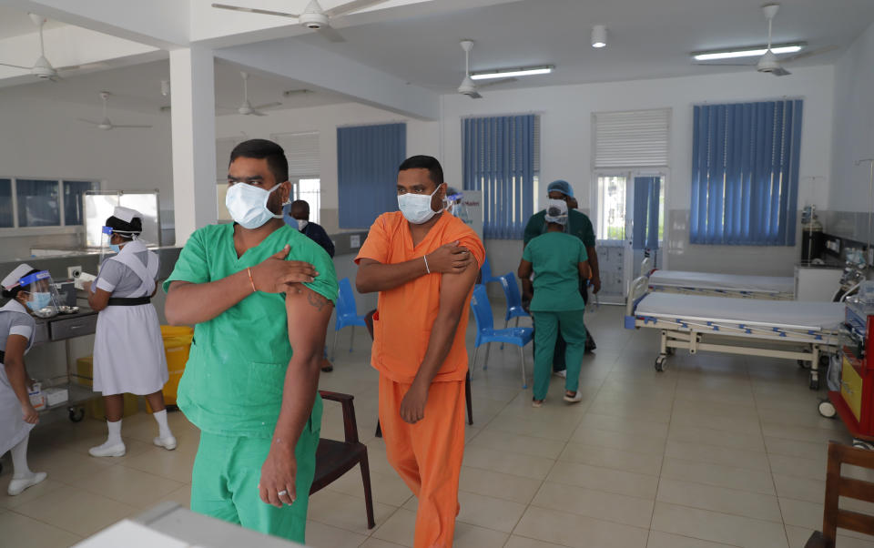 FILE - In this Jan. 29, 2021, file photo, Sri Lankan health workers leave after receiving COVID-19 vaccines in Colombo, Sri Lanka. The island nation has received 500,000 doses of the AstraZeneca-Oxford University vaccine donated by India and manufactured by the Serum Institute of India. (AP Photo/Eranga Jayawardena, File)