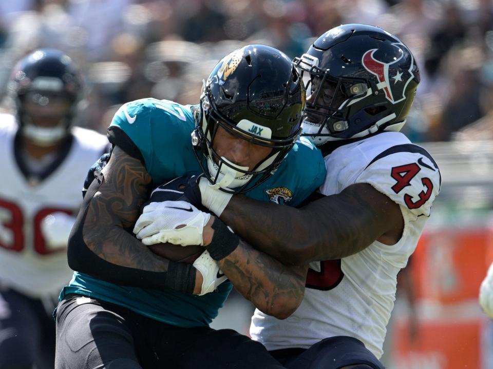 Evan Engram is tackled by the Houston Texans defense.