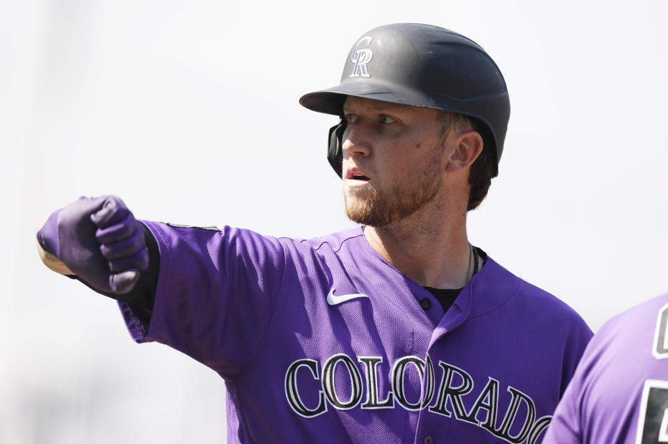 Colorado Rockies' Kyle Freeland gestures to the dugout after reaching first base with a two-run single off Los Angeles Dodgers starting pitcher Max Scherzer in the second inning of a baseball game Thursday, Sept. 23, 2021, in Denver. (AP Photo/David Zalubowski)