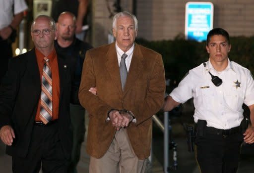 Former Penn State assistant football coach Jerry Sandusky leaves court in handcuffs after being convicted in his child sex abuse trial at the Centre County Courthouse in Pennsylvania on June 22. The jury found Sandusky guilty on 45 of 48 counts in the child sex abuse case that shocked the nation