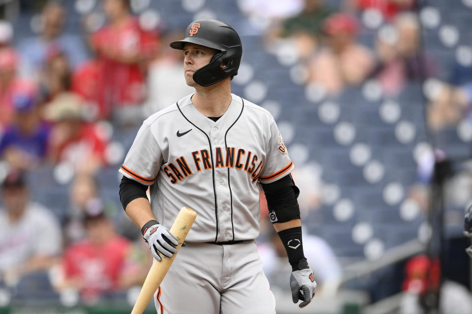 San Francisco Giants' Buster Posey looks on during the first baseball game of a doubleheader against the Washington Nationals, Saturday, June 12, 2021, in Washington. This game is a makeup of a postponed game from Thursday. (AP Photo/Nick Wass)