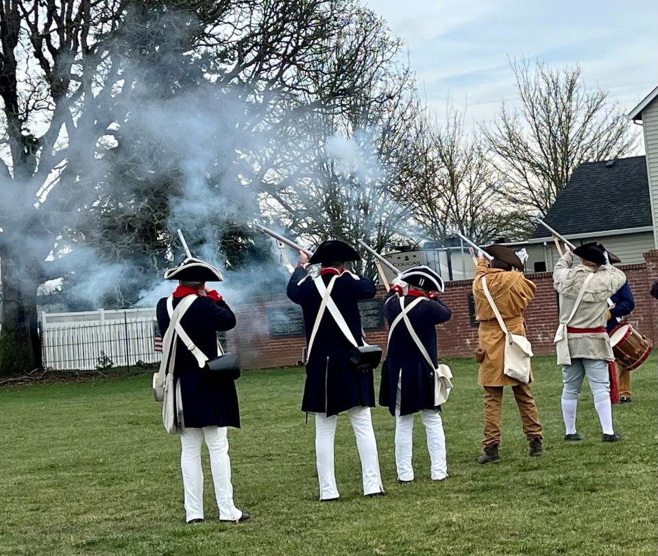 Members of the Sons of the American Revolution fire muskets during a ceremony at the gravesite of William Cannon, the only known American Revolutionary War soldier buried in Oregon.