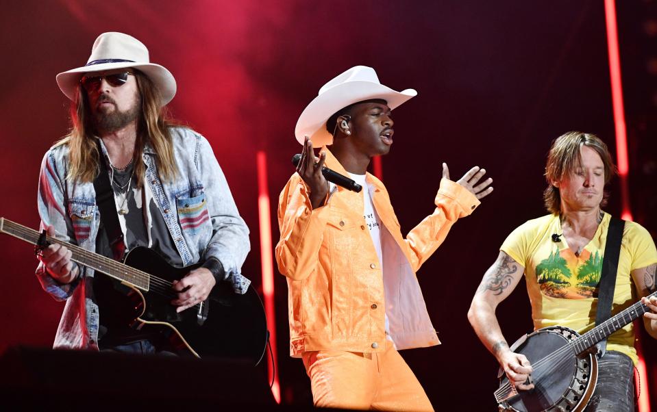 Billy Ray Cyrus, left, Lil Nas X and Keith Urban performs the huge hit, "Old Town Road," during the CMA Music Fest June 8, 2019 at Nissan Stadium.