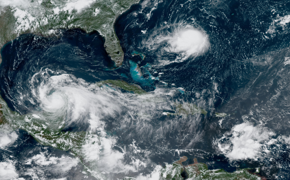 An August 2020 satellite picture shows the three tropical systems - Hurricane Grace (left), Tropical Storm Henri (center), and a new tropical wave - that the National Hurricane Center was tracking at the time.