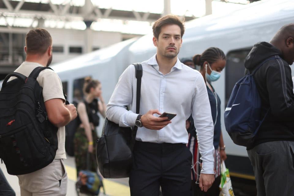 Passengers on a platform at Waterloo station, London (PA)