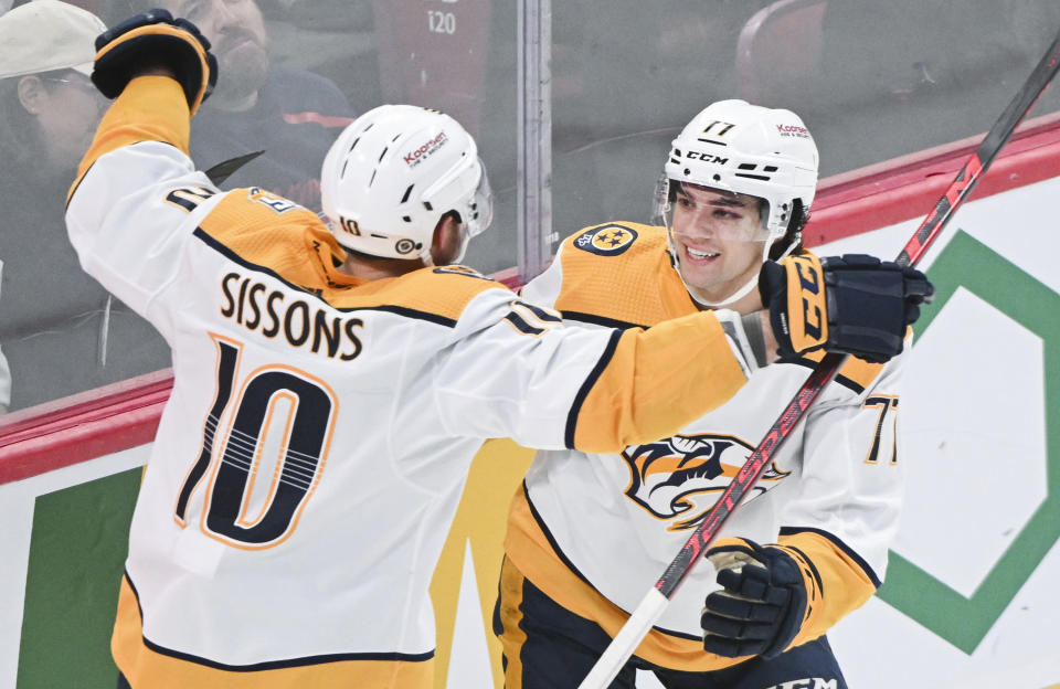 Nashville Predators' Colton Sissons (10) celebrates with teammate Luke Evangelista after scoring against the Montreal Canadiens during the second period of an NHL hockey game in Montreal, Sunday, Dec. 10, 2023. (Graham Hughes/The Canadian Press via AP)