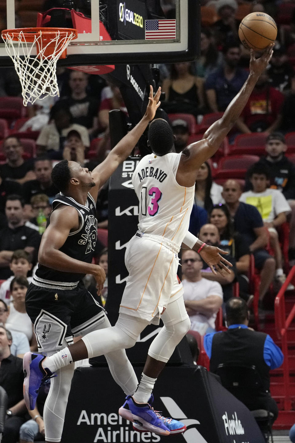 Miami Heat center Bam Adebayo (13) is fouled by San Antonio Spurs center Charles Basseyn (28) during the first half of an NBA basketball game, Saturday, Dec. 10, 2022, in Miami. (AP Photo/Lynne Sladky)