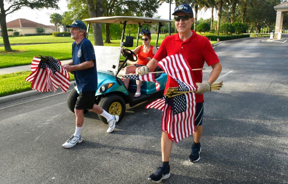 Yuri Linna, at right, a proud American citizen who immigrated from Finland, has been placing U.S. flags in front of homes in his Palm Bay neighborhood in advance of Memorial Day, Independence Day and Veterans Day, He was joined Friday by his wife, Janice, and his friend and neighbor, Neil Fischer. They want to honor members of the military, veterans, first responders and others who serve their community and the nation.