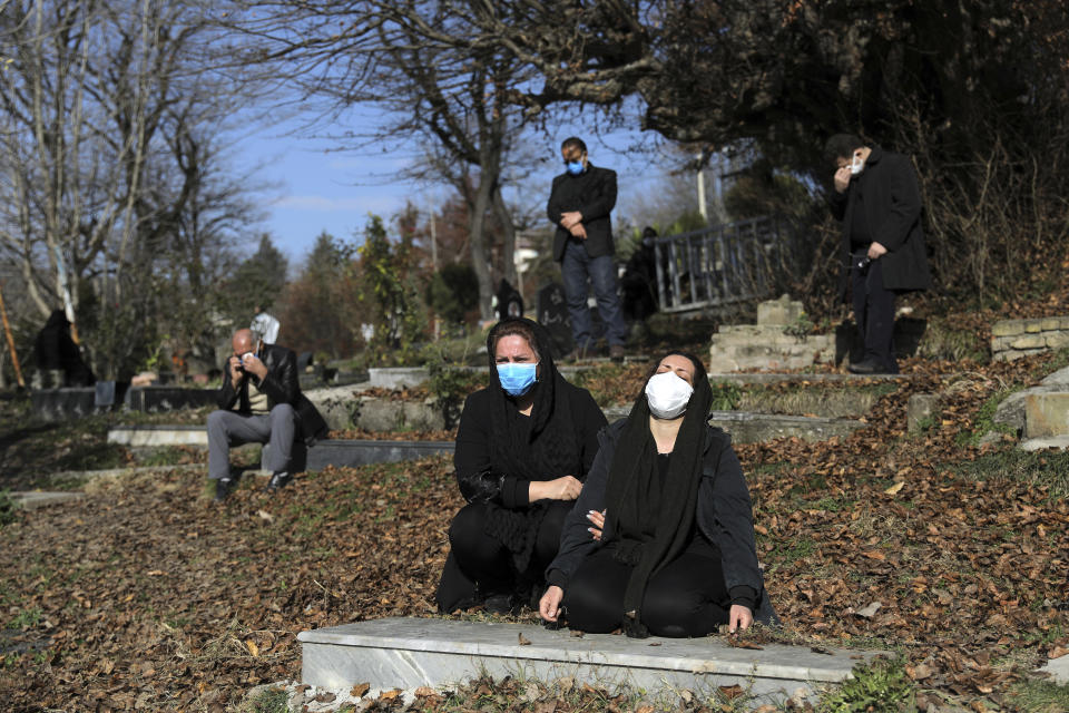 FILE - In this Dec. 17, 2020, file photo, mourners attend the funeral of a woman who died from COVID-19 at a cemetery in the outskirts of the city of Ghaemshahr, in northern Iran. The global death toll from COVID-19 has topped 2 million. (AP Photo/Ebrahim Noroozi, File)