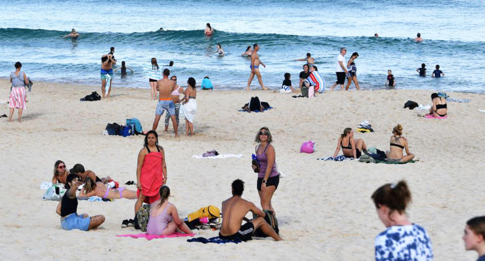 People sit at Bondi beach despite Sydney's stay at home orders. Source: Getty