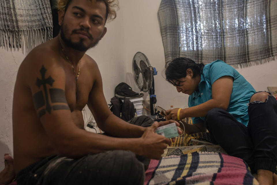 Honduran migrants Joseph Mateo, left, and Ricky, spend the day at a home in Monterrey, Nuevo Leon state, Mexico, Nov. 27, 2021, after obtaining one-year humanitarian visas allowing them to move about Mexico and work. (AP Photo/Felix Marquez)