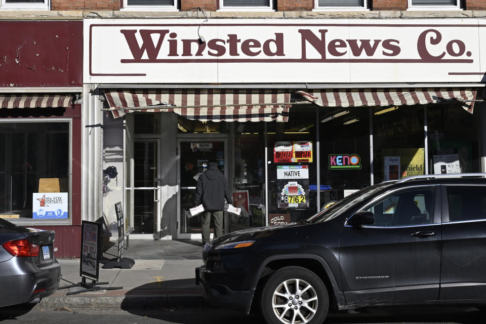 FILE - Andy Thibault, Editor and Publisher of The Winsted Citizen, carries bundles of the paper into the Winsted News Co., Friday, Feb. 3, 2023, in Winsted, Conn. After trying to buck a national trend of media closures and downsizing, the small Connecticut newspaper founded earlier this year with Ralph Nader's help has succumbed to financial problems and will be shutting down. (AP Photo/Jessica Hill, File)