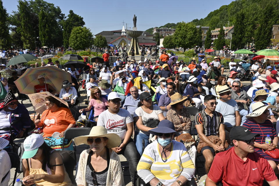 Spectators watch the holy mass celebrated by Pope Francis outside the Basilica of Sainte-Anne de Beaupre east of Quebec City, Thursday, July 28, 2022. (Bernard Brault /The Canadian Press via AP)