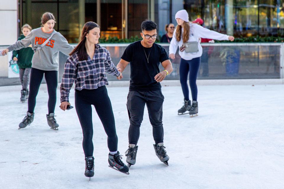 Andrea Reed and Rigel Quinal skate Nov. 18 at the Devon Ice Rink in downtown Oklahoma City.